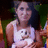 A pixelated image shows a person wearing a white tank top with a cartoon face graphic, standing against a dark background with green and orange elements.