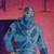 Pixelated figure in blue-toned attire against a pinkish-red gradient background with dark vertical elements.