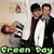 Two men in formal attire stand side-by-side with a baby in a striped outfit, while green text reads 'Rocks!!' and 'Green Day' on a pixelated background.