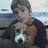 A pixelated image shows a person holding a dog with a white and brown face, overlaid with red text reading "IT IS ME AND MACEY" on a black background.