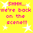 Yellow background with white star shapes and repeated pink text reading 'SHHH... we're back on the scene!!!' in pixelated font.