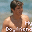 Pixelated image of a person with short dark hair wearing a sleeveless top, standing against a blurred background with text overlay.