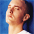 Pixelated close-up of a person's head and neck against a blue background, showing light skin tone, closed eyes, and a white garment at the bottom edge.