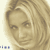 Static pixelated image of a person's face with light brown hair and neutral expression on beige background.