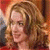 Pixelated portrait of a person with light brown hair, wearing a dark top against a warm-toned background with red and orange hues.