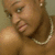 A person with a pearl necklace and earrings appears in two states: one with overlaid text and one without, against a neutral background.