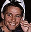 Four distinct pixelated portrait images arranged in a , each showing a smiling person with varied poses and backgrounds