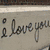 A four- shows a partial 'I love you' text, a black-and-white close-up of a person's face, a green heart drawing, and a blank