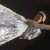 A pixelated figure in a white dress lies on a dark background with green text reading "Original Icons .com".