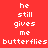 Red background with white pixelated text reading 'he still gives me butterflies' arranged in a , where some words are highlighted on blue rectangular backgrounds