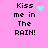 Pixelated text 'Kiss me in The RAIN!' on pink background with cyan heart or star-like animation elements.