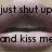 Pixelated image with dark text reading 'just shut up and kiss me' over a blurred background of muted purples and browns.