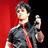 Pixelated image of a person in a dark shirt and red tie holding a microphone against a red and black background with blue text reading 'BILLIE !!!!!!!'