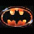 Static pixelated icon of a stylized bat symbol with orange and yellow gradient fill on dark background, featuring rounded edges and subtle light effects.