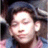 Pixelated close-up of a person's face with closed eyes, dark hair, and a neutral expression against a blurred background.