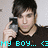 Pixelated image of a person with dark hair holding a camera to their face, wearing a dark shirt and necklace, with cyan text at the bottom reading "MY BOY... <3".