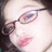 Pixelated close-up of a person's face showing eyes, nose, and lips with pinkish skin tones.