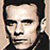 Static pixelated icon of a person's face with dark hair and neutral expression, rendered in low-resolution grayscale tones on a light background.