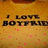 Pixelated text on a warm-toned background with scattered pink dots, showing partial words 'I LOVE' and 'BOTF' in dark brown letters.