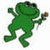 Green pixelated frog figure in a dynamic pose holding a brown object, with one arm raised and legs bent as if dancing or leaping.