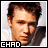 Two side-by-side pixelated frames of a man's face with text labels below each frame, displayed on a gray background.