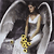 A pixelated figure with large white wings holds a golden sword with black accents against a dark background.