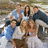 A static image with a blue background divided into four quadrants containing text and a pixelated group photo.