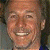 A pixelated contact sheet showing a smiling person on the left and green text reading "Original Icons .com" on the right against a dark background.