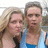 Two people stand close together in a pixelated image; the person on the left has long light brown hair and wears dark clothing, while the person on the right has short brown hair and wears a blue shirt.