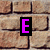 Brick wall background with scattered colored letters and numbers in black-outlined blocks.