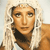 Pixelated image of a person with light brown hair wearing a white hooded garment and dark inner clothing against a light background.