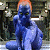 Pixelated blue figure with orange hair stands against a blurred background, next to green text reading 'Original Icons .com' on dark green.