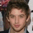 Pixelated portrait of a person with brown hair on blue background, text "JOHNNY" and "PACAR" in cyan block letters, small heart symbol.