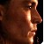 Pixelated close-up of a person's face in profile, showing dark hair, a nose, and a mouth against a dark background.