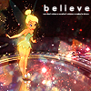 A pixelated fairy character in a green dress stands on a reflective surface with sparkles, under a dark background with the word 'believe' in white text.