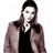 Static 48x48 pixel icon of a person with long brown hair wearing a black top and light brown jacket against white background.