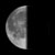 A grayscale crescent moon icon with a pixelated texture, showing a smooth gradient from light to dark across its curved surface against a solid black background.