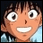 Pixelated anime-style character face with wide eyes and a broad smile, next to stylized text on a black background.