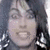 A pixelated image of a person with long dark hair and large earrings, split into two sections with red text on the right.