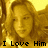 A pixelated image of a person with long light brown hair, wearing a yellow top against a golden background.