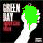 A hand holds a dripping liquid shape in green, red, or blue against black background with 'GREEN DAY' text above and 'ROCK' below.