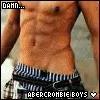 Pixelated close-up of a shirtless person's torso wearing striped swim trunks with text overlay at bottom.