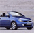 Blue convertible car with white roof, side view, wheels visible, against light gray background.