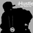 Black silhouette of a person wearing a cap and hoodie with a white circular pendant, standing against a gray background with partial text reading 'Hustle' in the upper right.