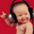 A pixelated image of a person wearing large black headphones with silver ear cups, set against a solid red background.