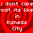 Red spiral background with white text repeating 'i dont care i dont care wat its like' and 'in Kansas City' in four quadrants.