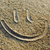 A four- shows a sand smiley face, text reading "That smiley thinks your gay," a shirtless man on a beach, and an empty