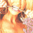 A pixelated image of a smiling person with light brown hair and a pink floral-patterned garment, viewed from a low angle.