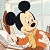 Pixelated cartoon character with large black ears and orange outfit on left, green background with pixelated text 'Original Icons .com' on right.