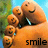 Pixelated orange cartoon character with multiple smiling faces, blue eyes, and a light blue collar against green foliage and sky background.